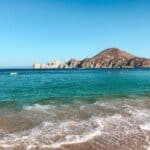beach in cabo san lucas with mountain in the back