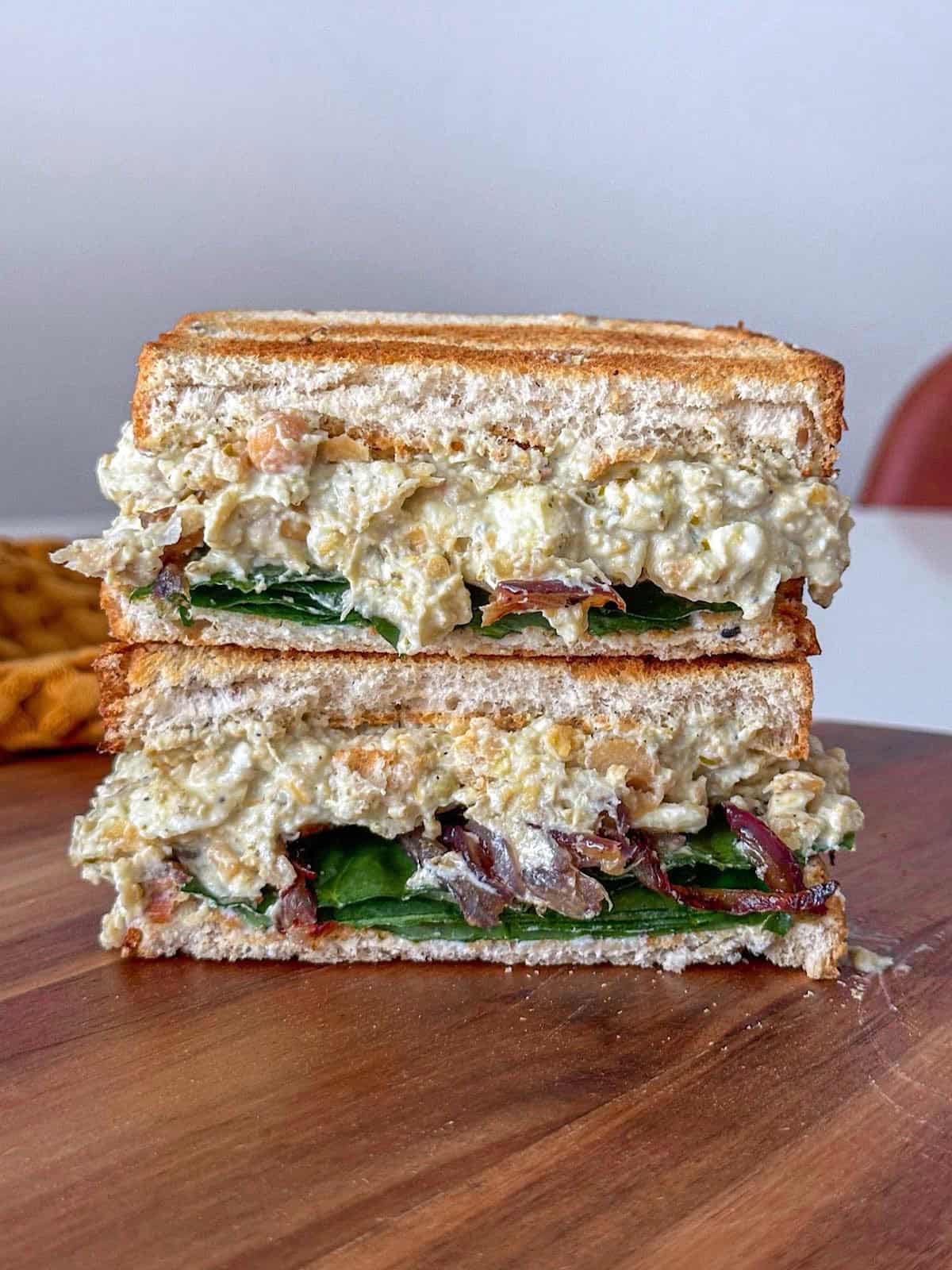 Caramelized Onion Chickpea Salad Sandwich 1 Caramelized onion chickpea salad sandwich made with toasted whole grain bread, a creamy chickpea mixture, fresh spinach, and sweet caramelized onions stacked in layers.