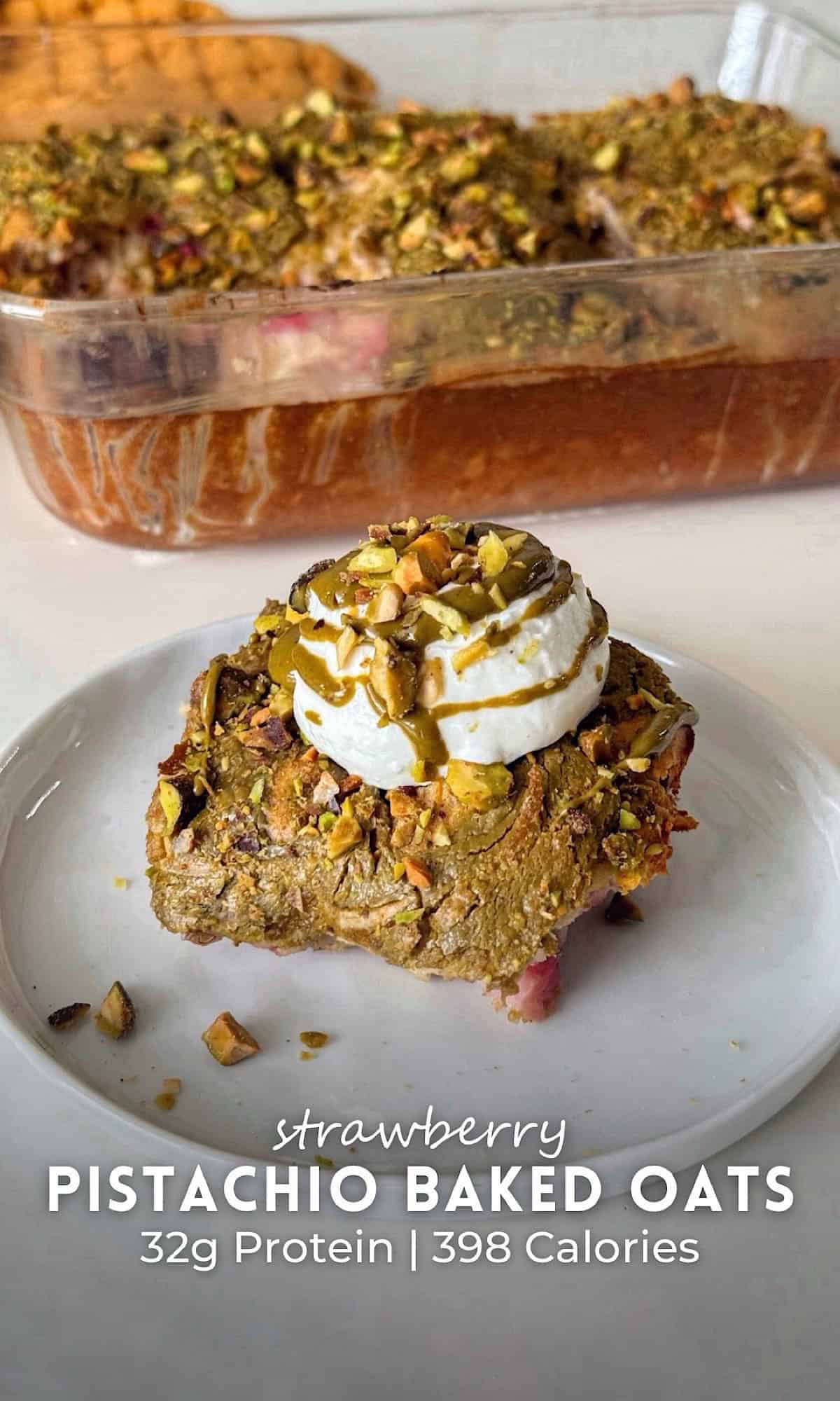 Strawberry Pistachio Baked Oats 5 Slice of strawberry pistachio baked oats topped with a dollop of yogurt, pistachio butter drizzle, and chopped pistachios, served on a white plate with the full baked dish in the background.
