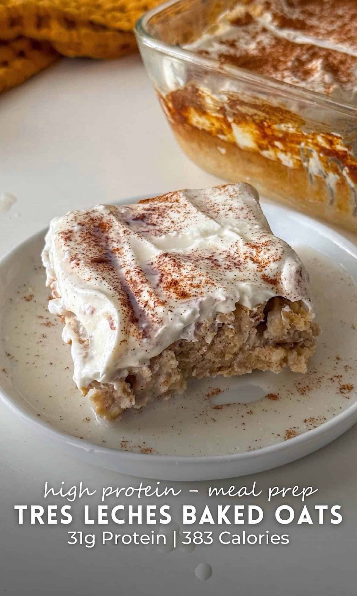 Meal Prep Tres Leches Baked Oats 10 A square slice of tres leches baked oats topped with whipped cream and cinnamon, served on a white plate with milk pooling around the edges and a glass baking dish in the background.