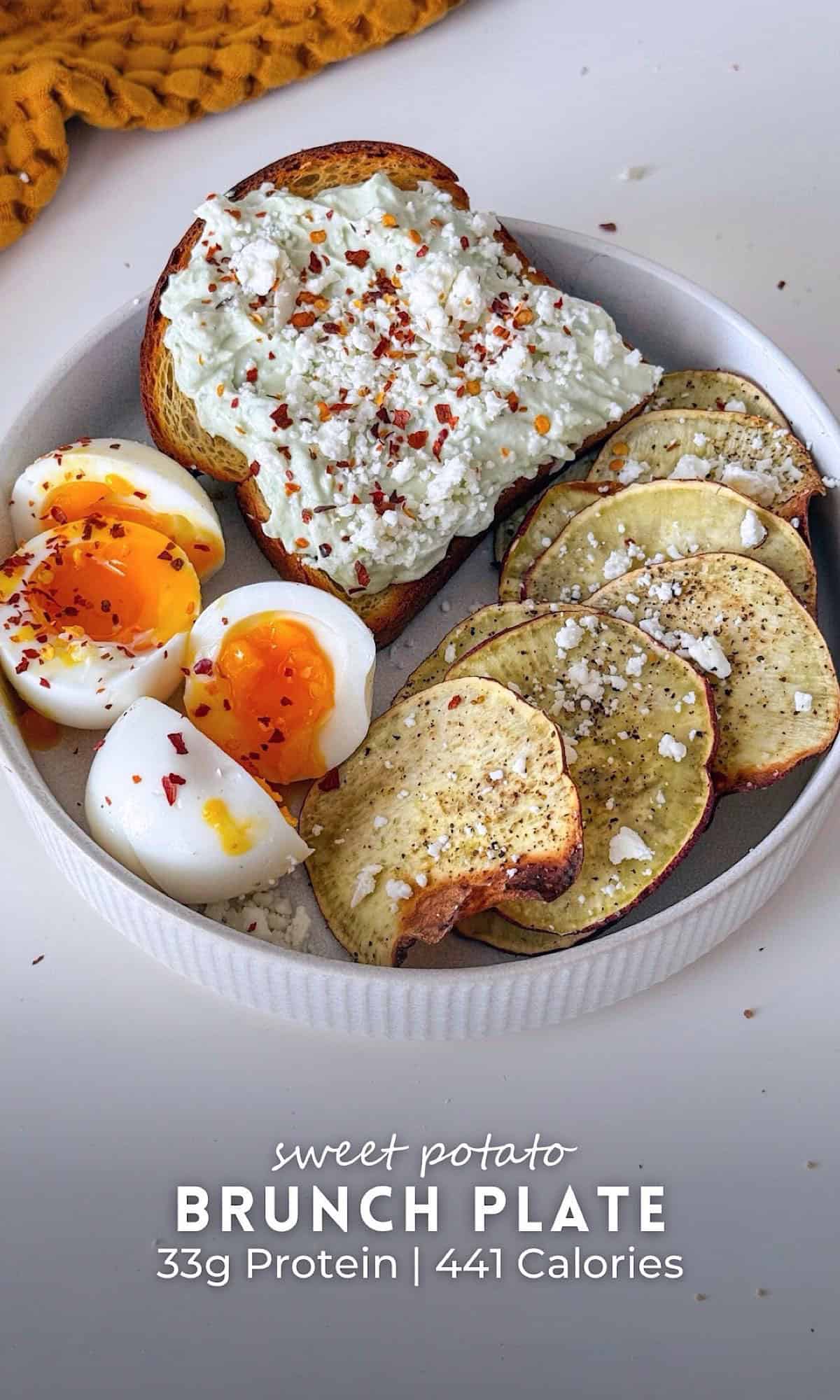 Sweet potato brunch plate featuring crispy air-fried sweet potato chips, soft boiled eggs with runny yolks, and avocado yogurt toast topped with crumbled cheese and red pepper flakes.