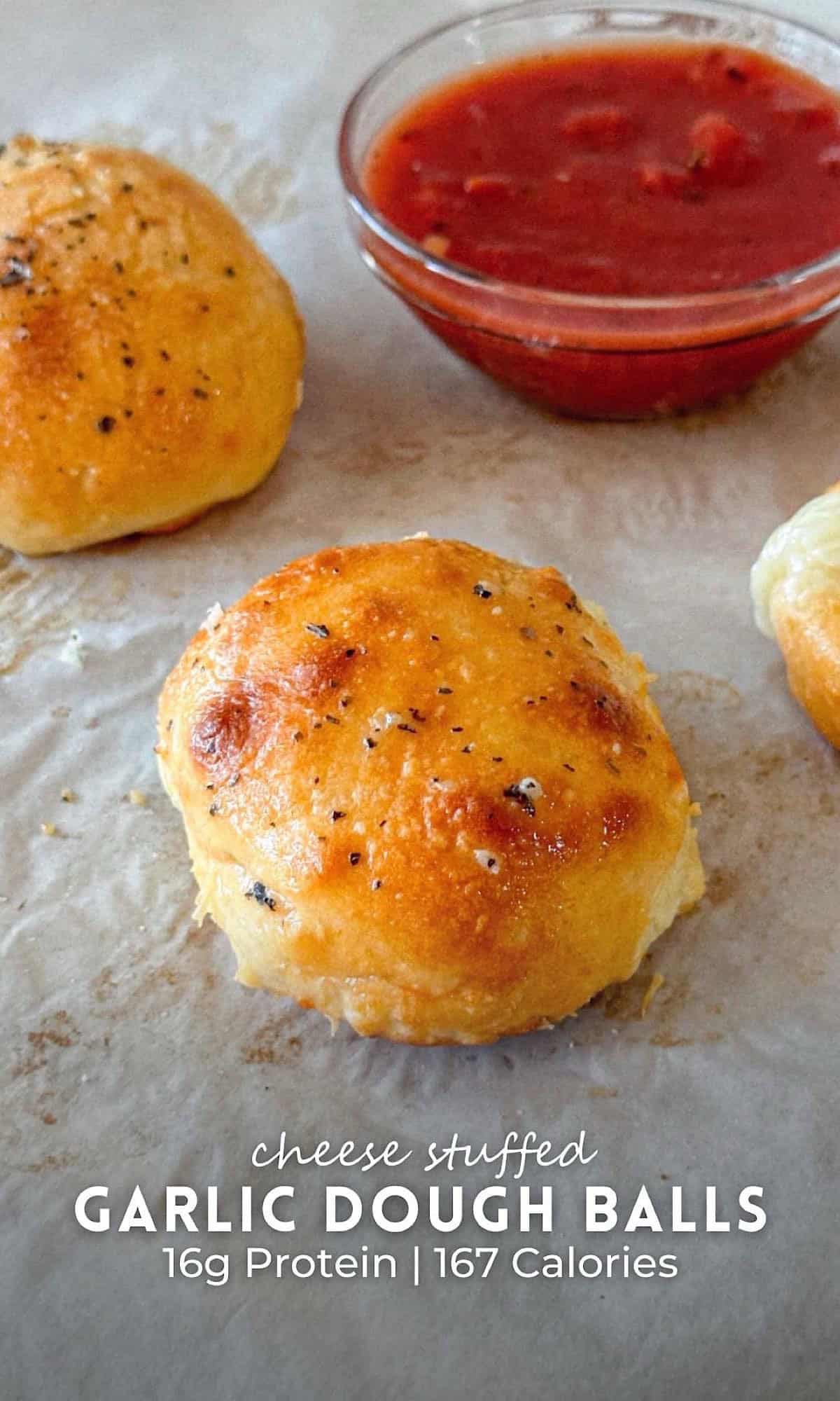 Cheese Stuffed Garlic Dough Balls 10 Cheese stuffed garlic dough balls baked to golden perfection, served on parchment paper with a side of marinara dipping sauce, showcasing a crispy, herbed exterior and gooey cheese center.
