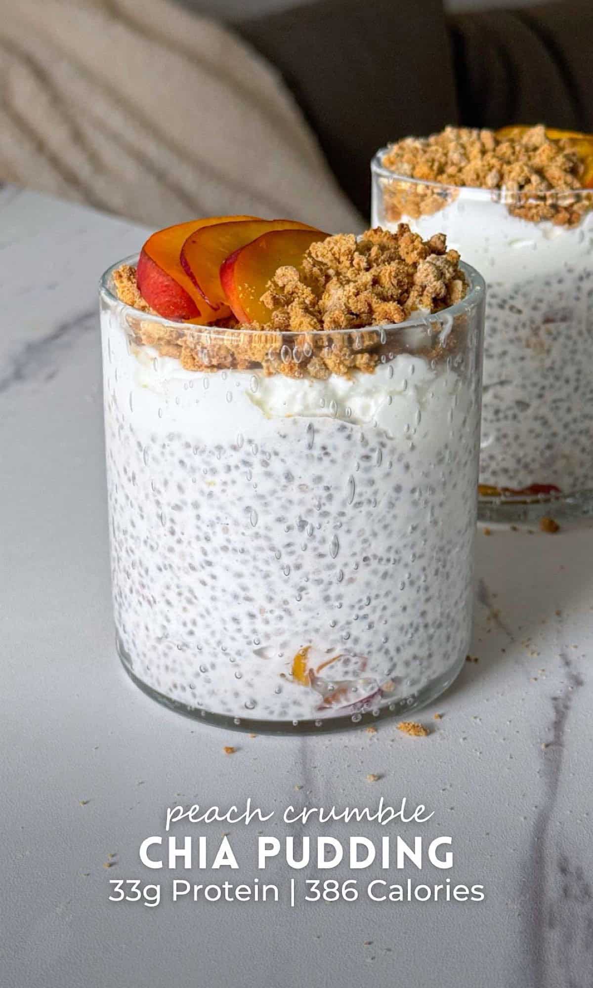 Peach Crumble Chia Pudding 11 Two glasses of peach crumble chia pudding layered with juicy peaches and creamy chia pudding, topped with yogurt, fresh peach slices, and a golden oat crumble.