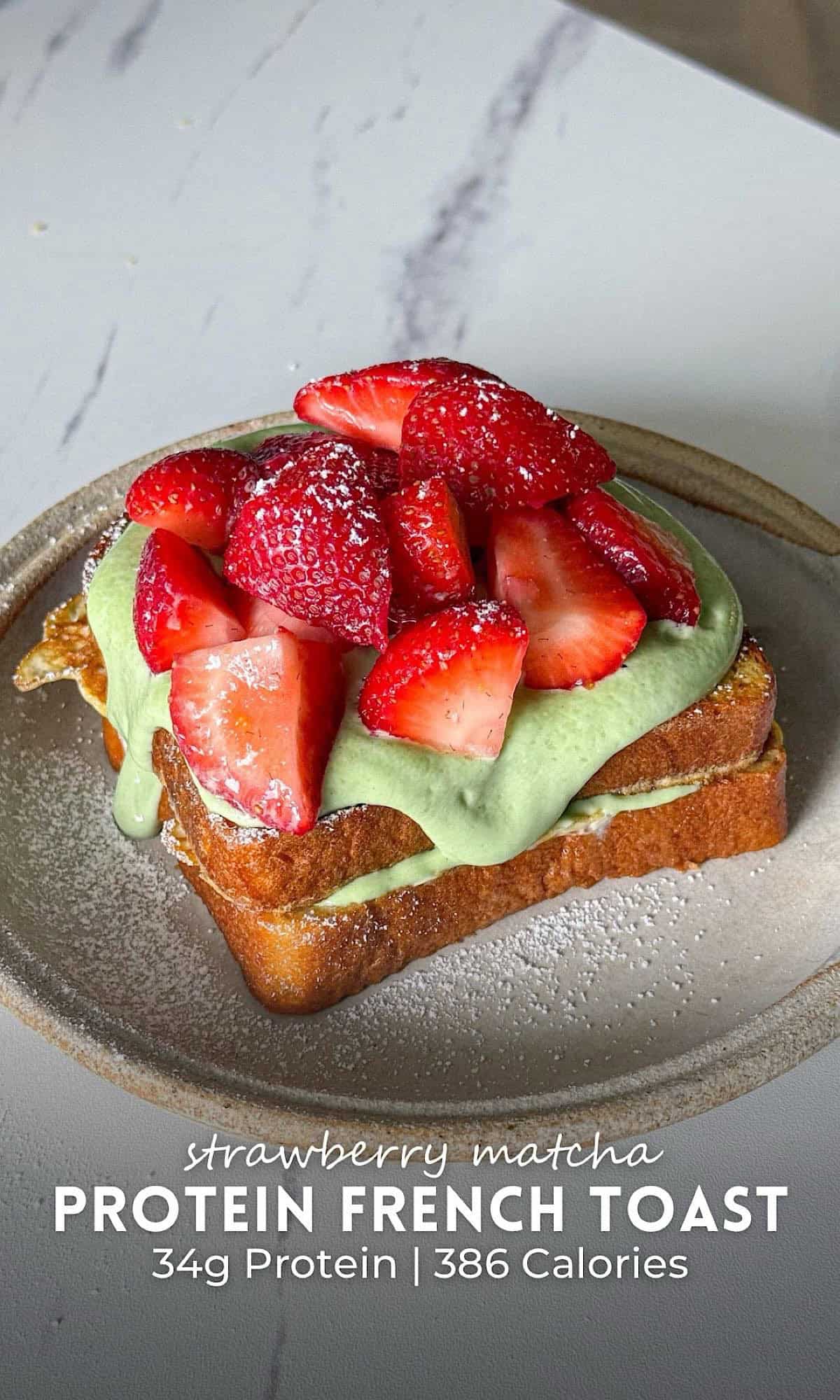 Strawberry Matcha French Toast 10 Strawberry matcha French toast stacked with thick slices of golden French toast layered with a creamy matcha filling and topped with fresh strawberries and a light dusting of powdered sugar. This strawberry matcha French toast is served on a rustic ceramic plate, combining sweet berries with earthy matcha for a vibrant, high protein breakfast.