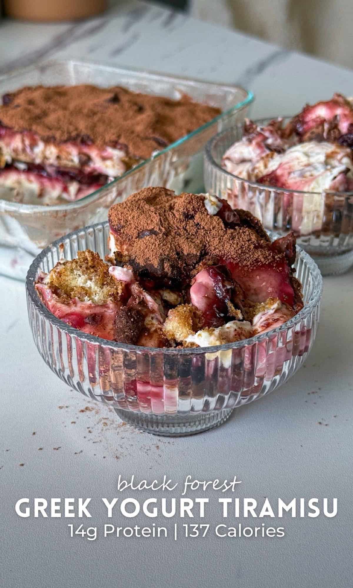 Black Forest Greek Yogurt Tiramisu 11 Black Forest Greek yogurt tiramisu layered with creamy yogurt, chocolate cake, and cherry filling, dusted with cocoa powder and served in glass dessert bowls.
