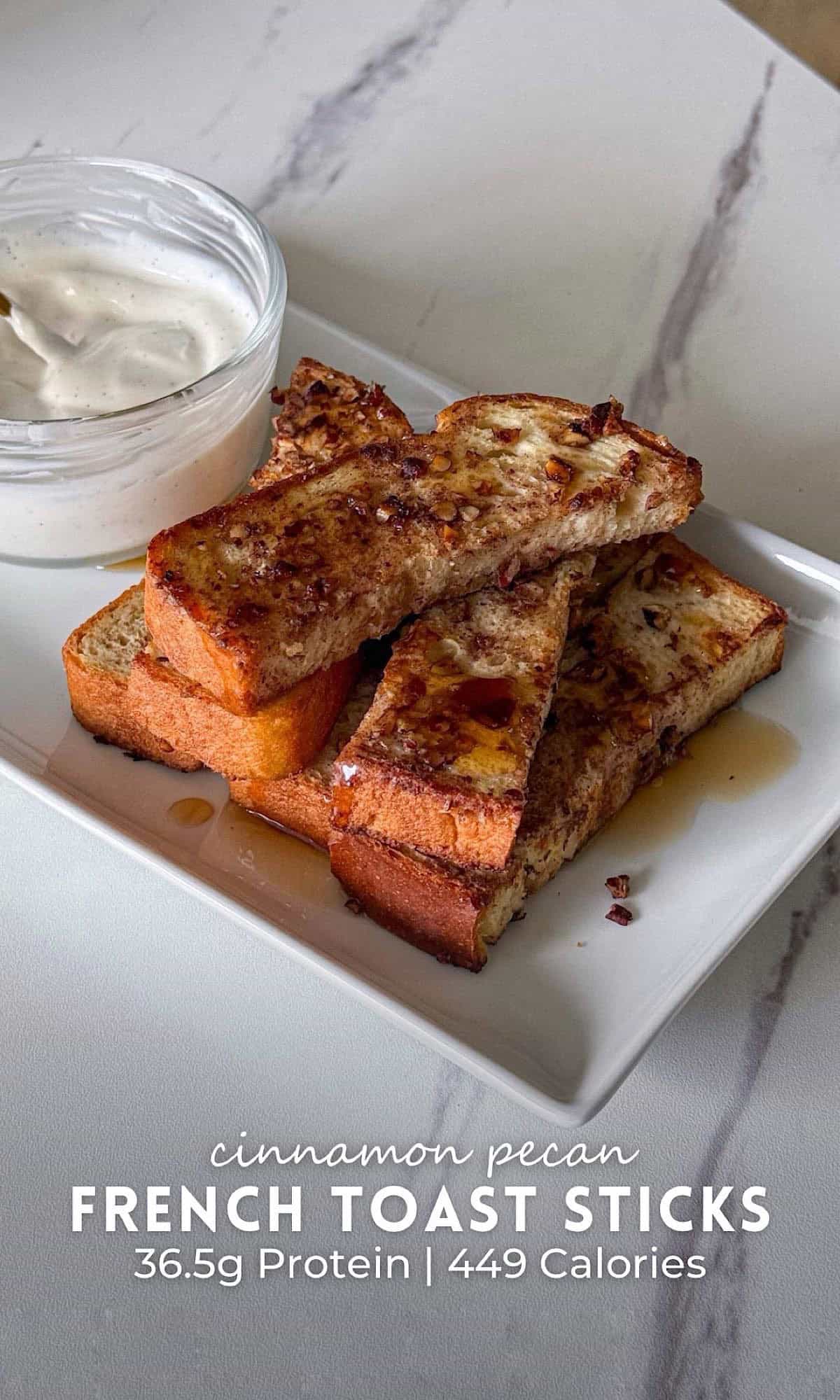 Cinnamon Pecan French Toast Sticks 10 Cinnamon pecan French toast sticks stacked on a white plate with chopped pecans and syrup, served alongside a creamy yogurt dipping sauce.